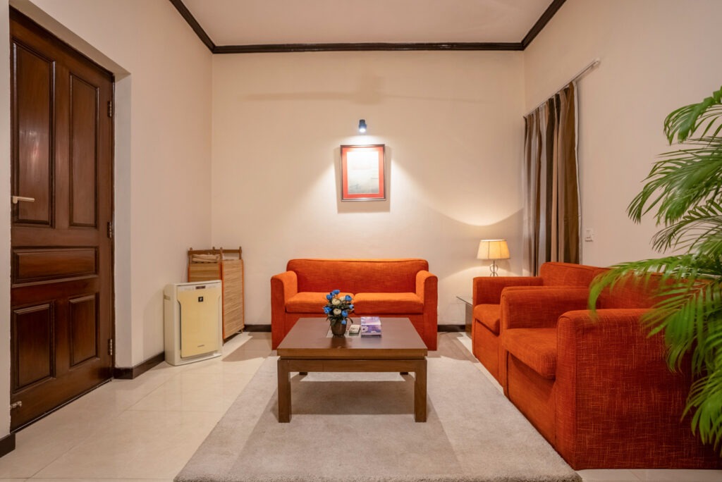 Comfortable service apartment living room with sofa seating and modern interiors