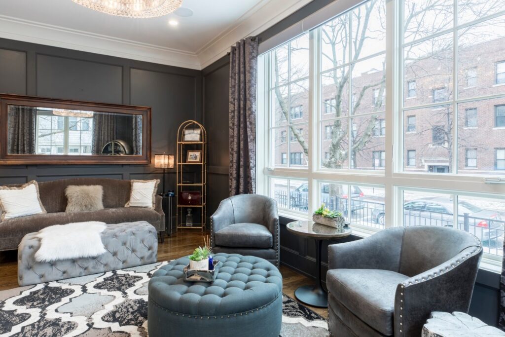 Luxury serviced apartment living room with large windows and elegant modern furnishings